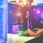 Young gamer playing at e-sports competition – Male guy having fu
